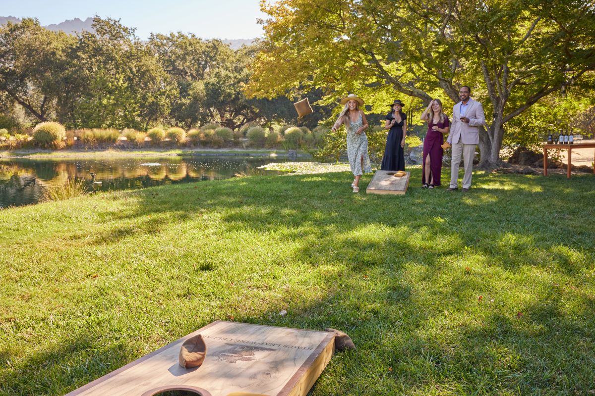 People playing cornhole outside at FAY Lake